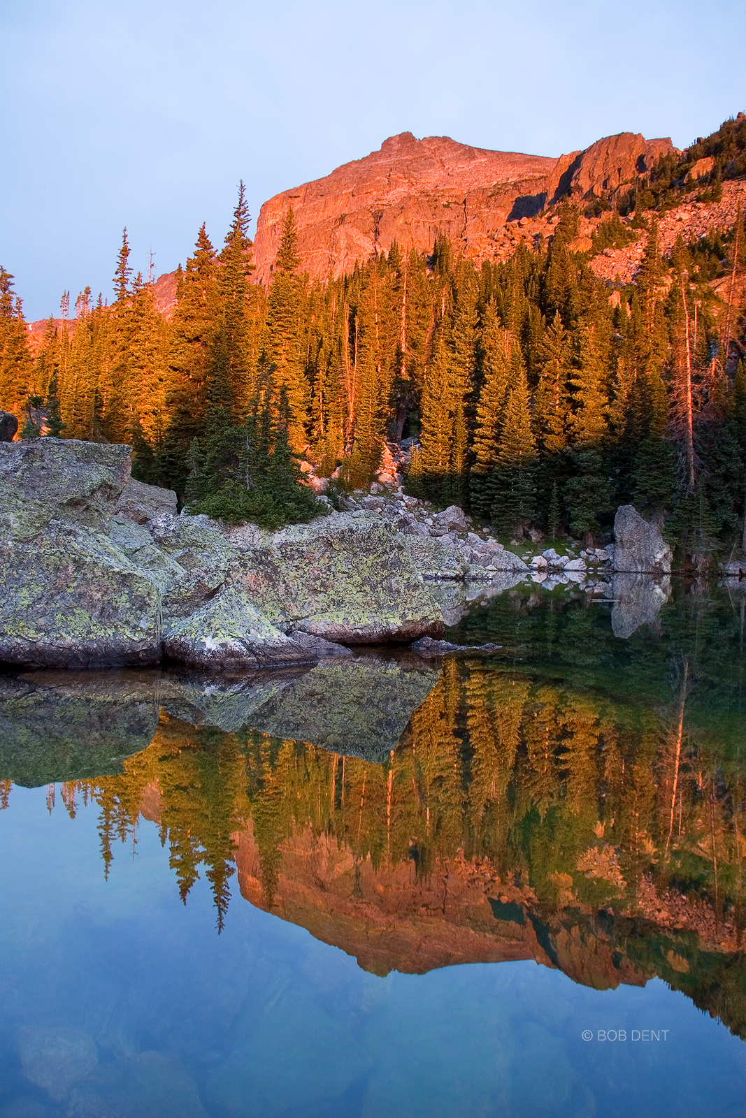 Sunrise bathes Hallett Peak in red, Lake Haiyaha, Rocky Mountain National Park, Colorado.