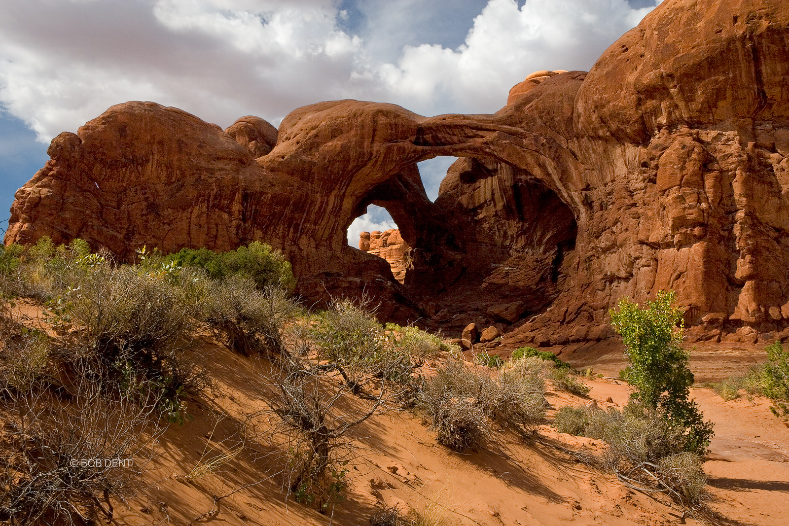 Afternoon clouds gather above Double Arch, Arches National Park, Utah.