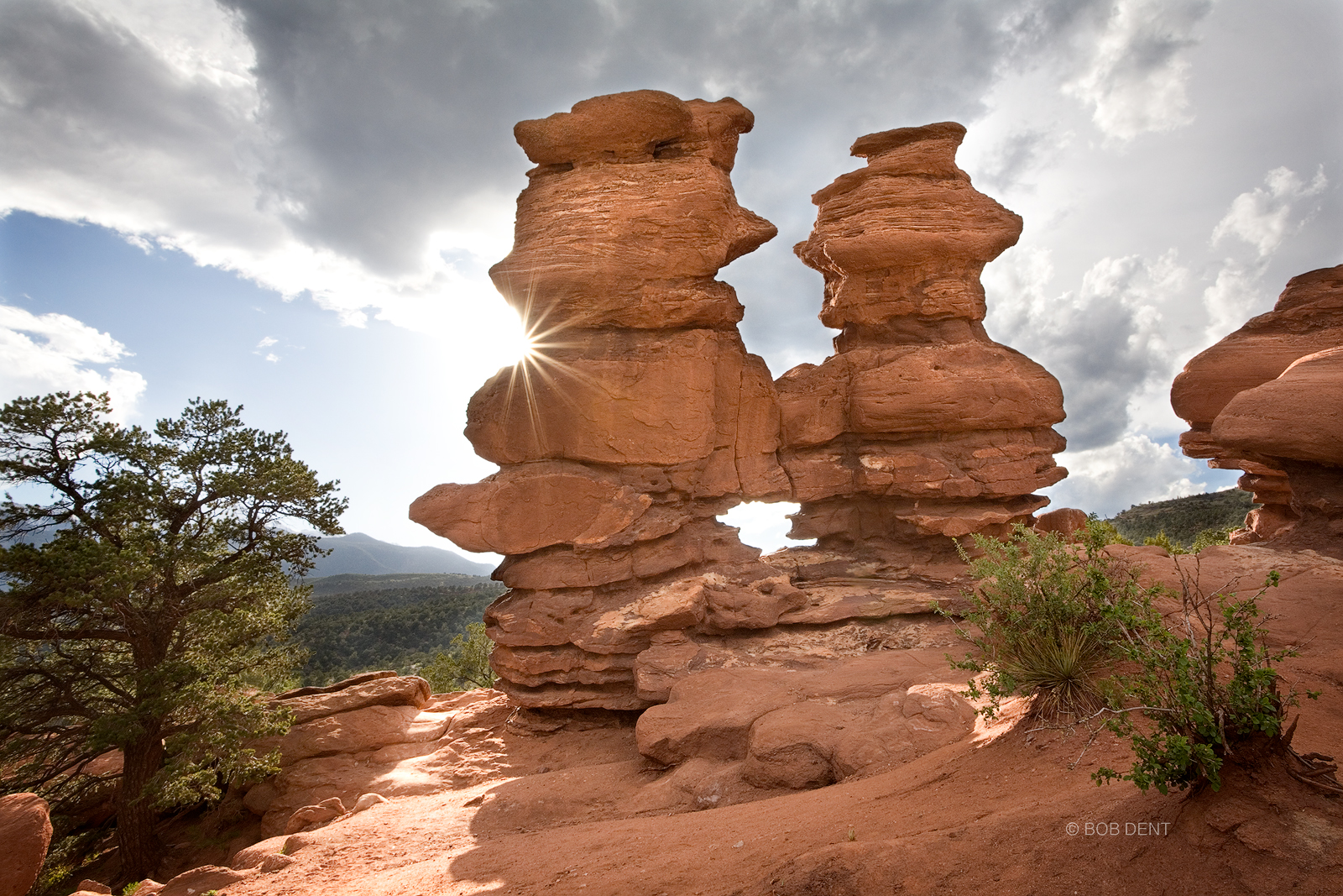 The sun descends behind the Siamese Twins, Garden of the Gods, near Colorado Springs, Colorado.