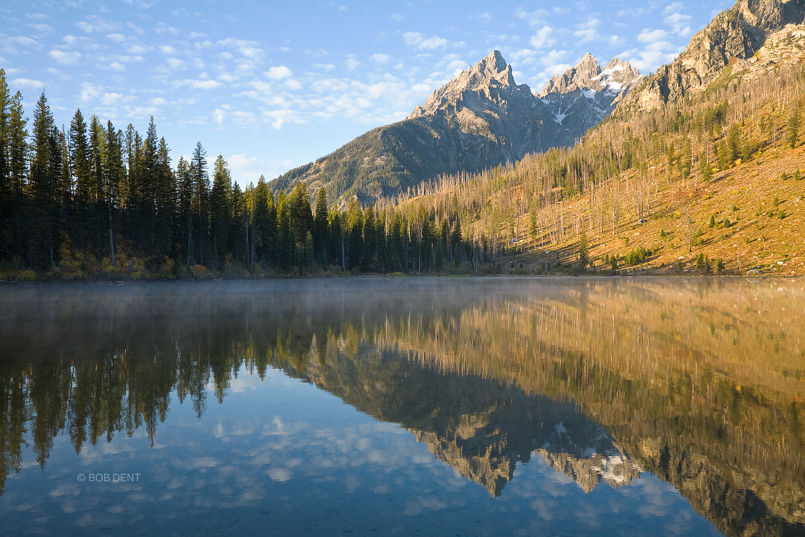 The Tetons reflecting in a misty String Lake at sunrise, Grand Teton National Park, Wyoming.