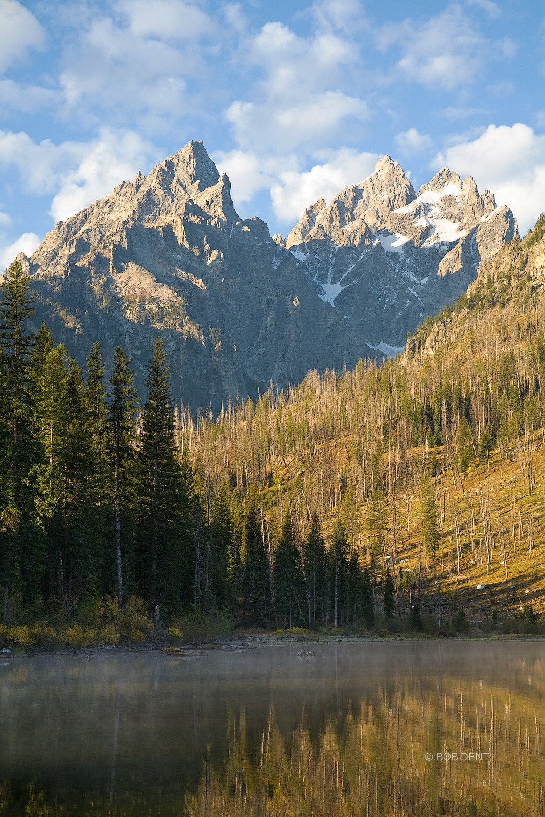 Sunrise light on the Tetons at a misty String Lake, Grand Teton National Park, Wyoming.