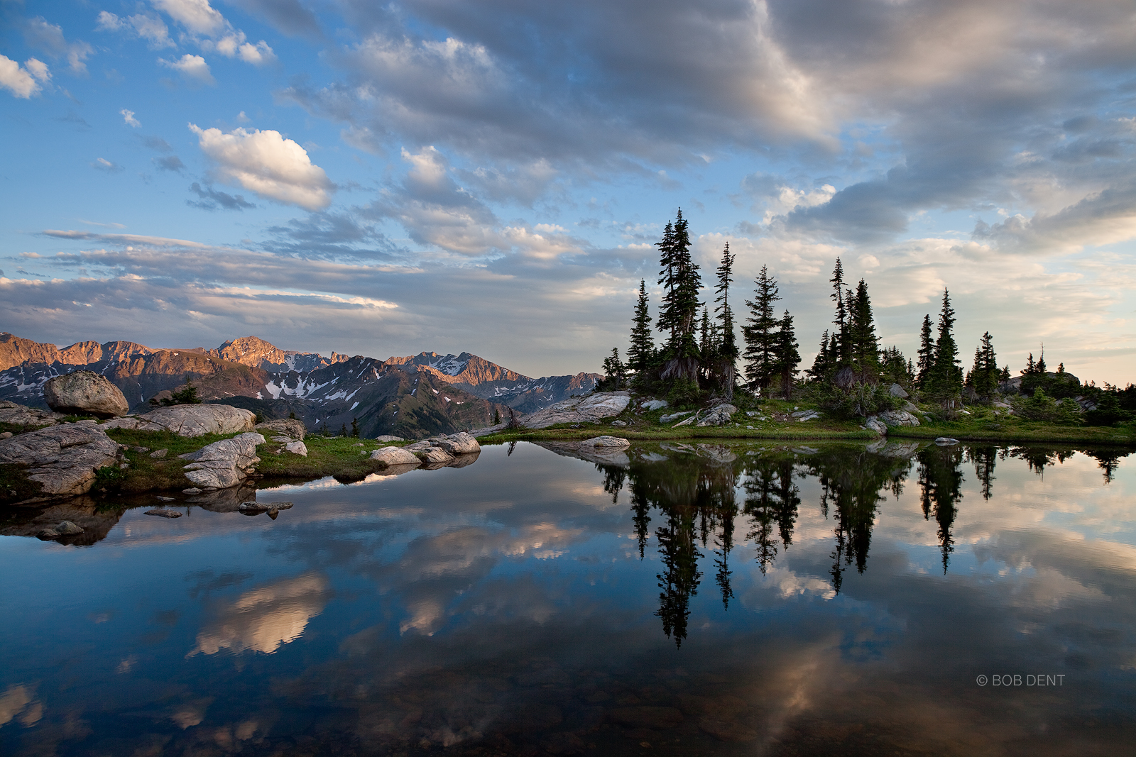 Clouds reflecting in an alpine pool at sunset. Indian Peaks Wilderness, Colorado.