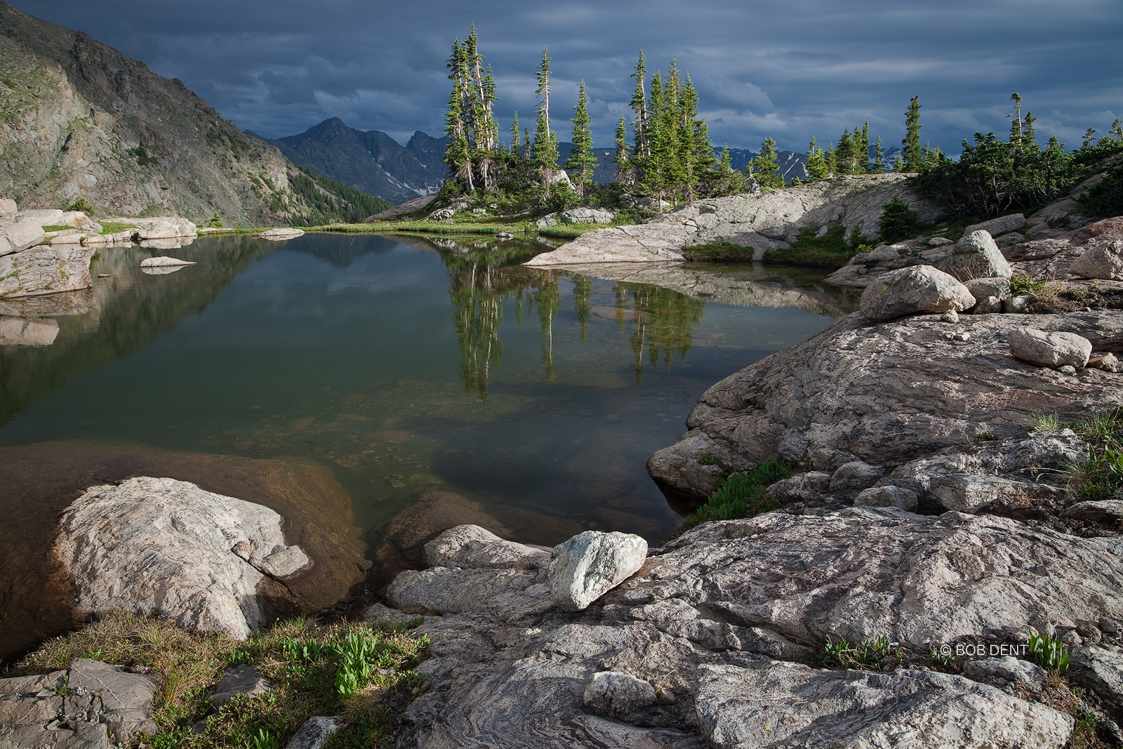 Dark clouds gathered over the Indian Peaks, as seen from an alpine pool at timberline. Indian Peaks Wilderness, Colorado.