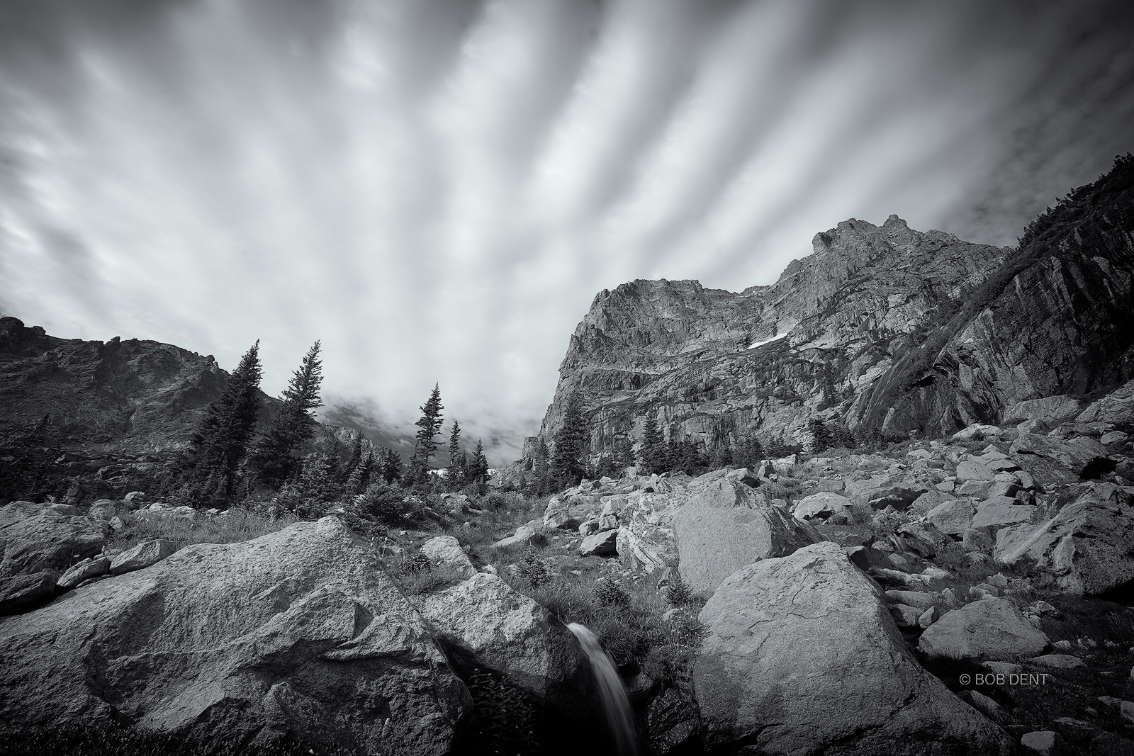 Clouds fan across the sky above Notchtop Mountain, Rocky Mountain National Park, Colorado.