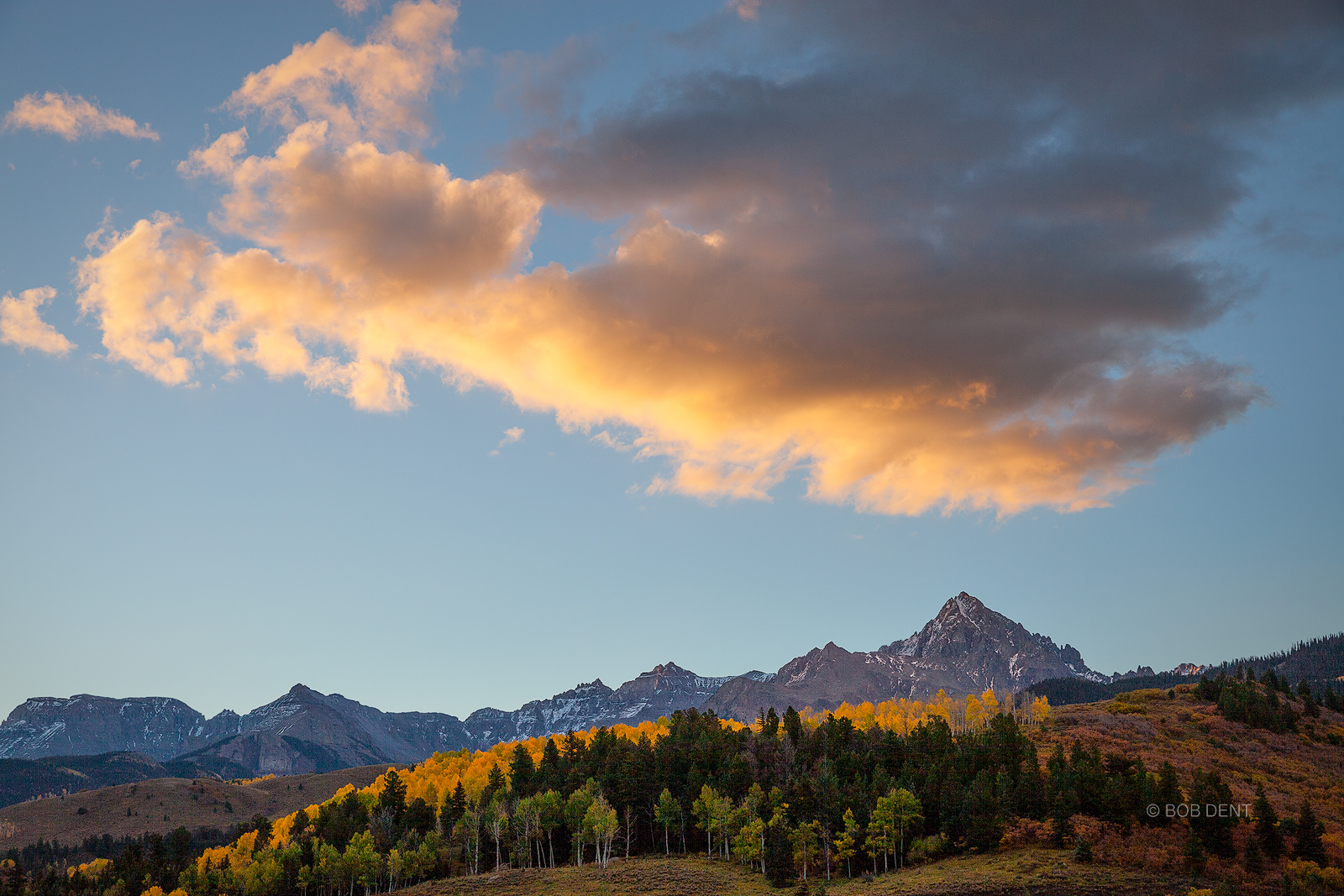 Sunrise colors a large cloud formation over Mt. Sneffels.